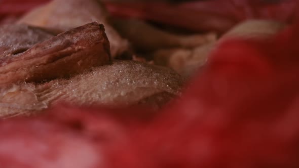 Closeup View of Hands in Gloves Packing Chicken Legs From a Box Into Individual Plastic Bags