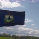 Vermont Flag on a Flagpole Waving in the Wind Blue Sky Background - VideoHive Item for Sale