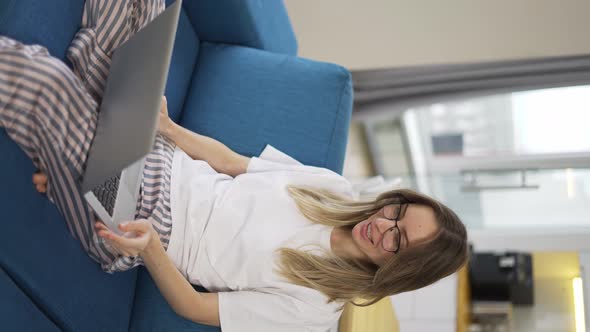 Blonde Woman Make Video Call Using Laptop Sit on Sofa Greeting Someone