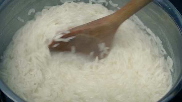 Boiling Rice Stirred In Pot