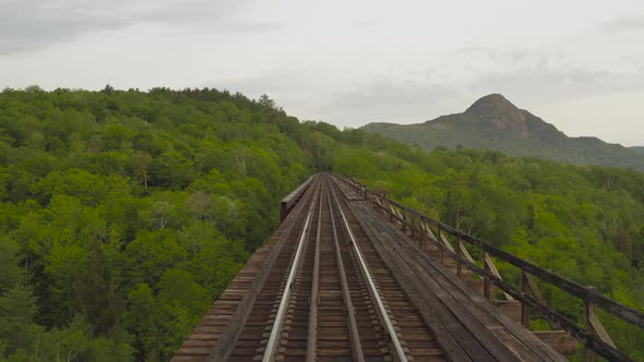 Aerial low angle Onawa trestle bridge railway tracks