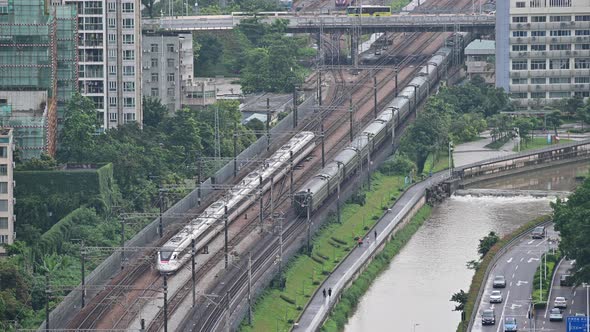 Aerial view of Shenzhen metro train move fast on the track with overpass transportation