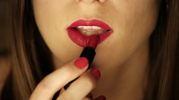 Sexy Woman Paints Her Lips With Red Lipstick