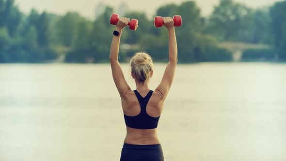 Woman Exercising With Dumbbells. Cardio Fitness Training. Outdoor Pumping Muscles Practicing.