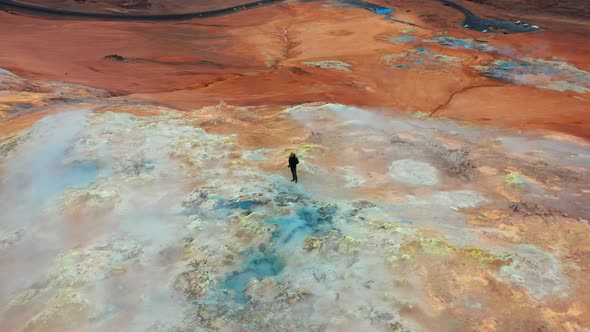 Figure Standing In Steaming Volcanic Terrain Of Myvatn