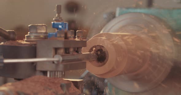 Man working on a wood lathe creating art - slow motion macro shot