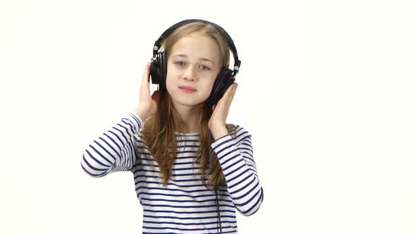 Teenager Girl Listens Music on Headphones, Shakes Head To Beat