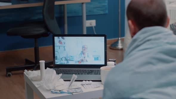 Sick Man Using Video Call Telemedicine for Consultation