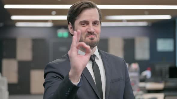 Portrait of Businessman Showing Ok Sign with Finger