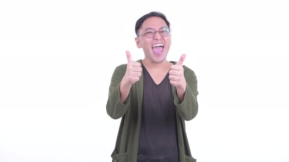 Happy Japanese Man with Eyeglasses Giving Thumbs Up and Looking Excited