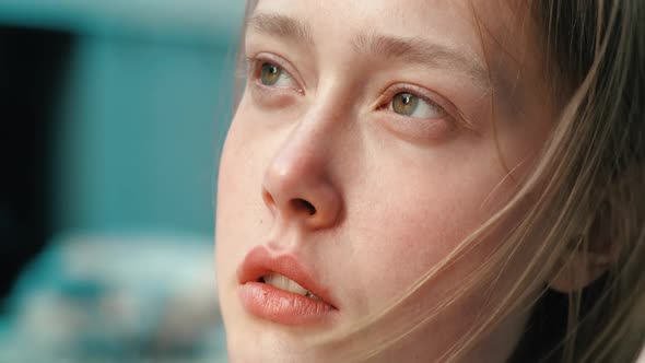 Close Up Portrait of Attractive Young Girl is opening hey green Eyes, windy Shoot.