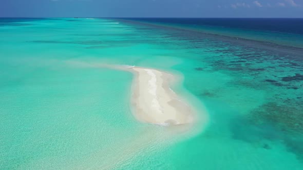 Aerial drone shot panorama of idyllic lagoon beach break by clear water with white sand background o
