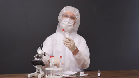 Male Scientist Is Testing a Sample of Biological Tubes Contaminated By Coronavirus Covid 19