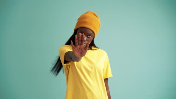 Concentrated African woman showing stop sign