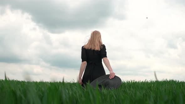 Girl In Black Dress Goes By The Field.