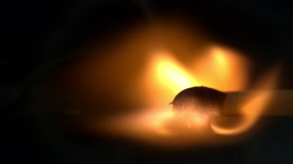 Super Slow Motion Macro Shot of Igniting Match Against Black Background at 1000Fps.