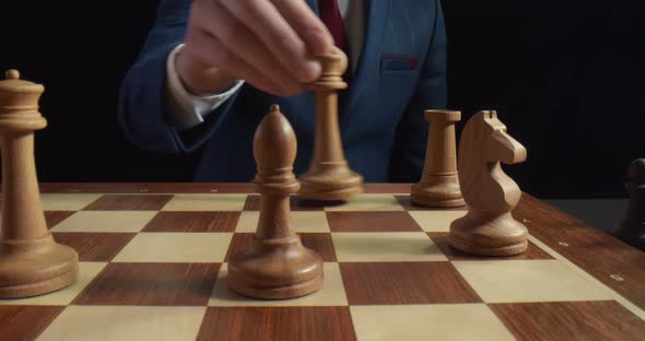 Close Up of Player Making Castling Move To Protect White King During Chess Game