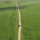 Top view on the driving car of the mountain road through the green field - VideoHive Item for Sale