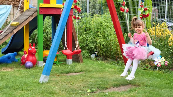 Cute little girl on a swing.	