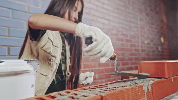 Young Girl Laying Bricks in Construction Theme