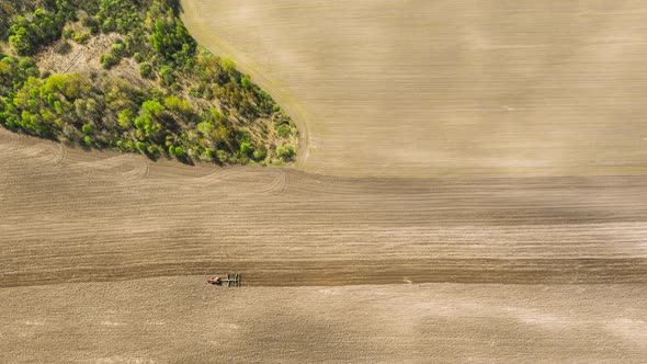 Tractor Plowing Field In Spring