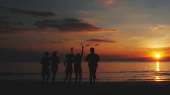 Silhouette young running on beach and sunset sky