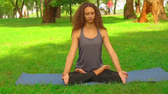 Female Meditates in Park