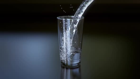 A Jet Of Water Is Poured Into A Glass Glass