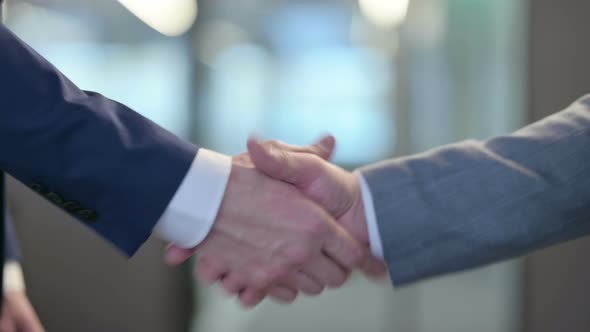 Hand Shake By Two Businessmen at Work