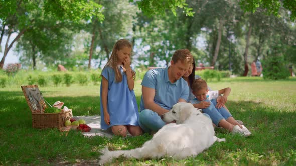 Happy Family Use Tablet on Picnic