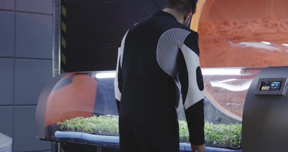 Scientist Controlling Plant Incubator alt