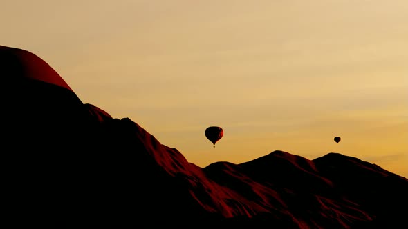 Hot Air Balloons Flying Above Mountains at Sunset