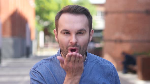Portrait of Man with Flying Kiss for His Girlfriend
