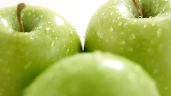 Close-up of green apples with water droplets