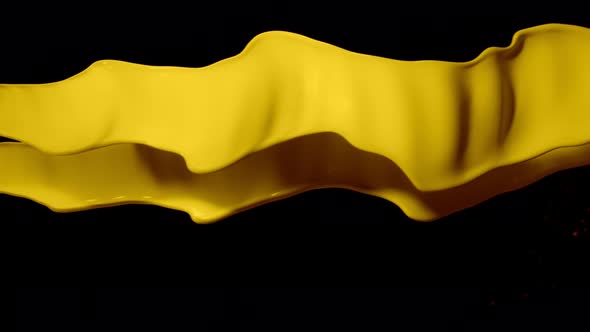 Super Slow Motion Shot of Twisting Yellow Splash at 1000Fps Isolated on Black Background