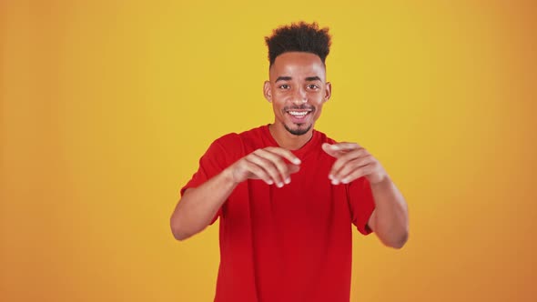 Energetic African American Guy Dancing Orange Studio Background