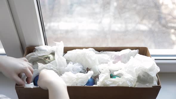 Woman Open Christmas Toys in Cardboard Box