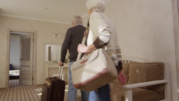 Delighted Mature Caucasian Couple Moving into Hotel Suite