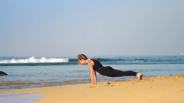 Girl Changes Yoga Pose Cobra To Downward-facing Dog Pose