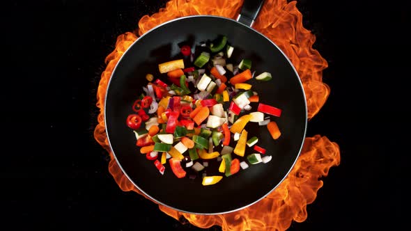 Super Slow Motion Shot of Throwing Vegetables on Frying Pan and Fire Blast at 1000Fps