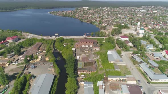 Aerial view of old red brick factory next to the river and pond 14