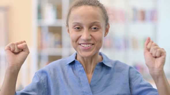 Portrait of Excited African Woman Celebrating Success