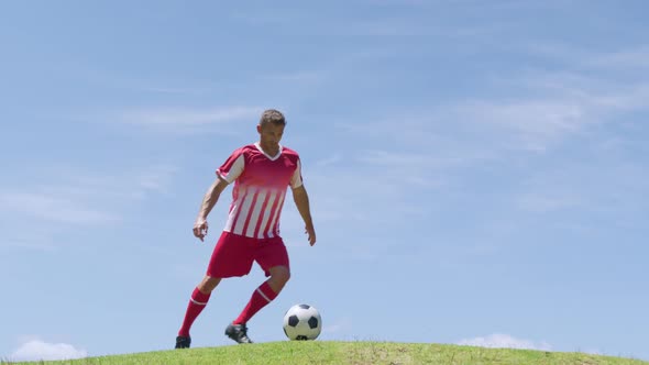 Soccer player kicking ball on the field