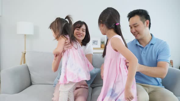 Portrait of Asian happy family spend time with kid together in house.