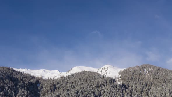 Snow Mountain Peaks With Passing Clouds