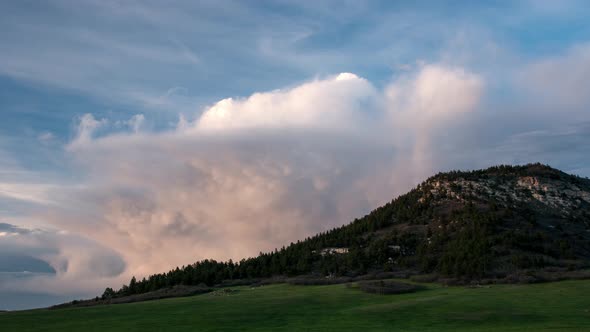View of Bald Mountain as storm clouds move behind it at sunset