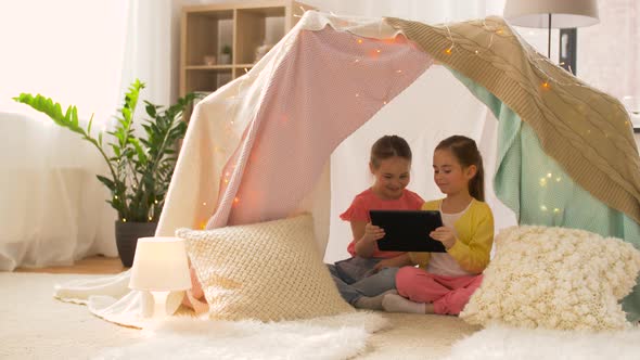 Little Girls with Tablet Pc in Kids Tent at Home