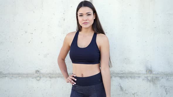 Smiling Ethnic Sportswoman Standing Near Wall