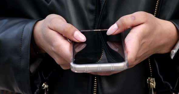 Close up of black woman hands using a smart phone.