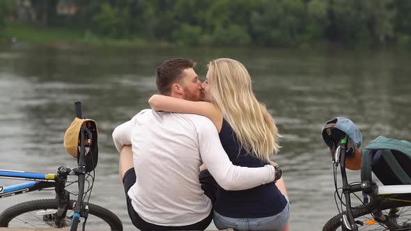 Happy Loving Couple on Bicycles By a River